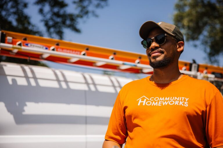 A man in a Community Homeworks Shirt.