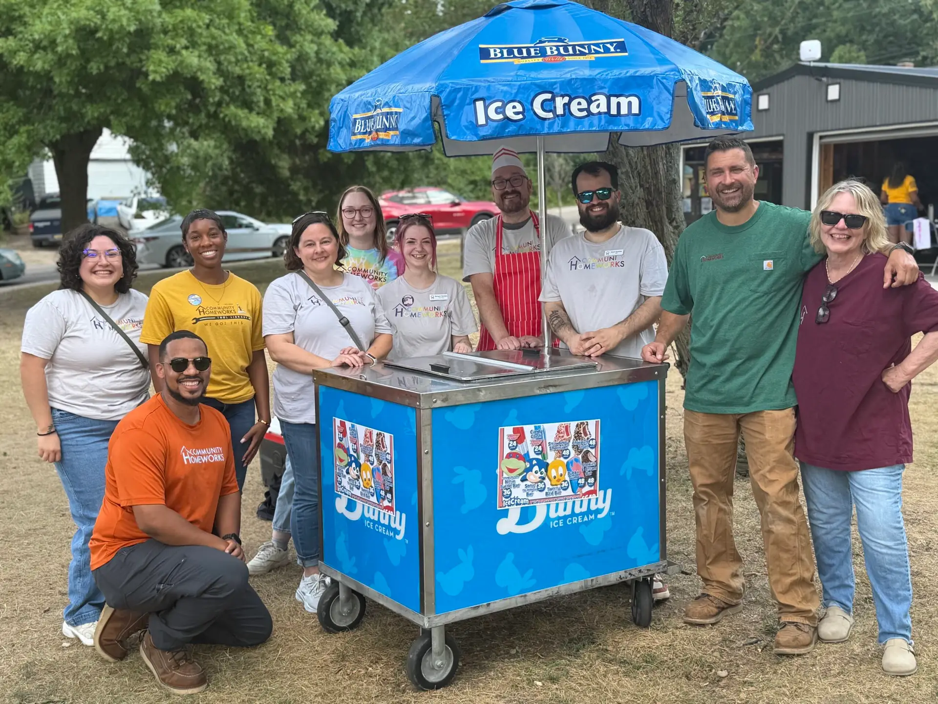 Community Homeworks team standing by an ice cream cart.