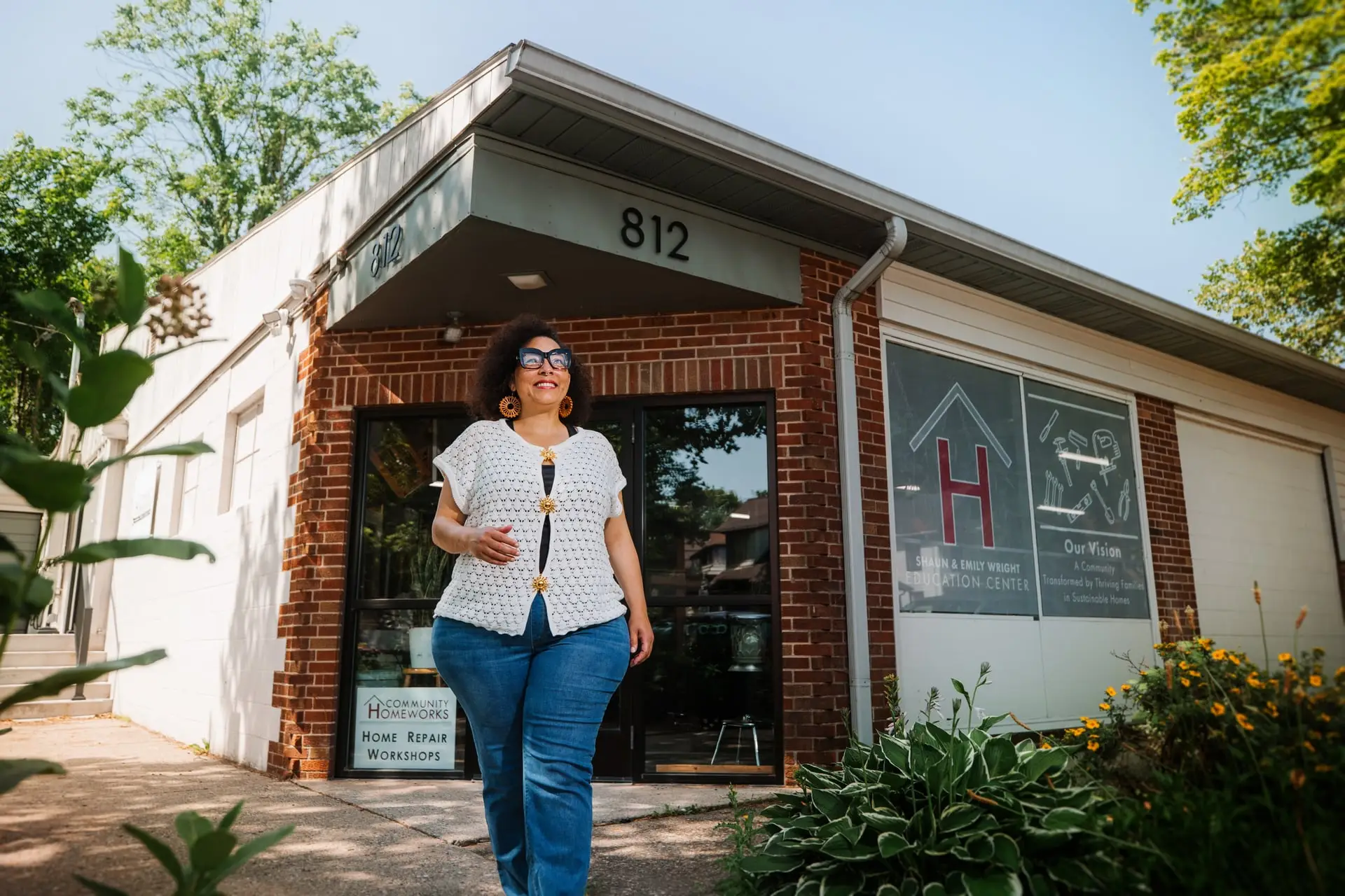 A woman walking out of the Community Homeworks building.